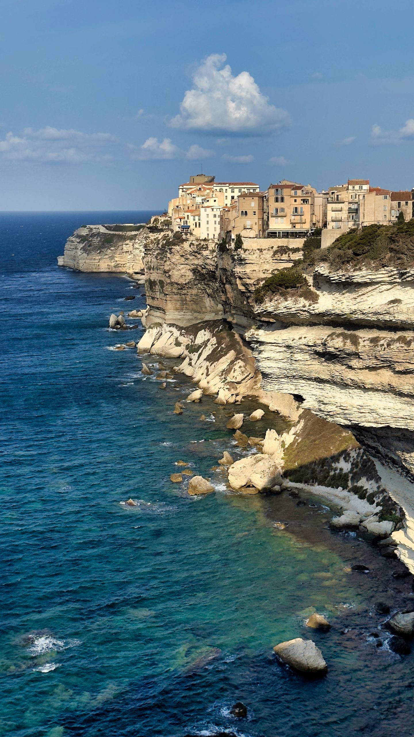 The old town of Bonifacio perched on white limestone cliffs above the Mediterranean